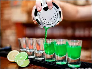 Barman nalewa drinki do kieliszków