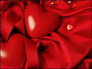 na czerwonym materiale dwa serduszka